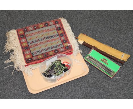 A tray of Dolmetsch recorder, boxed Hohner Rheingold harmonica, five Persian design small mats and a small box of costume jew