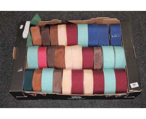 A box of spools of vintage hat trim 