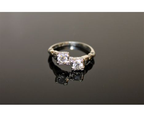 An antique two stone diamond ring in 18ct white gold, each stone approximately 0.35ct.