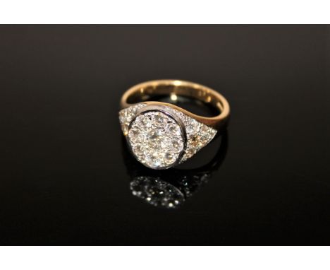 A superb quality 18ct gold diamond set signet ring, the centre stone weighing approximately 0.6 carat, surrounded by an addit