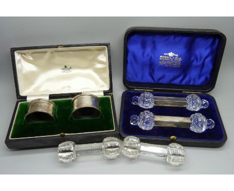 A pair of silver napkin rings in a Mappin &amp; Webb box, 34g, cased, a pair of glass and silver knife rests and another pair