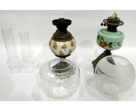 Early 20th century oil lamp with painted green opaque glass reservoir, over a tapering square metal base with dimpled clear g