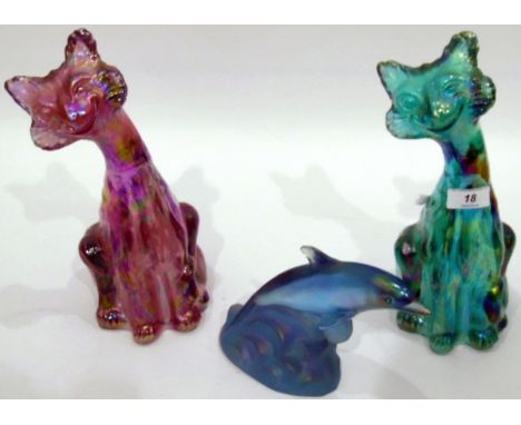 Two Fenton carnival glass cats, one in iridescent turquoise, with sticker, 29cm high, the other in iridescent amethyst, 28cm 
