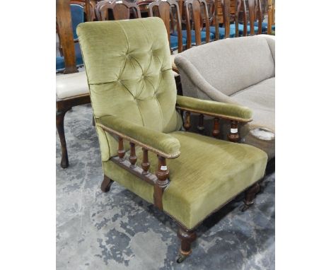 Late 19th/early 20th century open armchair, the green upholstery with button back, the arms with turned supports 