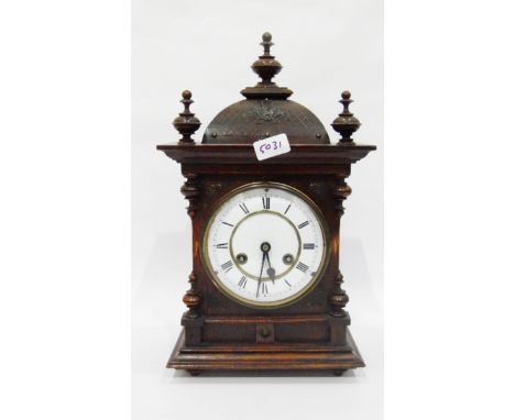 Oak cased mantel clock with three turned finials to the domed top, white enamel dial, striking movement, 44cm high approx 