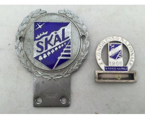 A Skal part enamel car badge by J.R. Gaunt of London and a Skal enamel lapel badge dated 31st March - 4th April 1965.