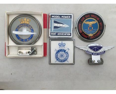 A cased Submarines Club car badge, a Sabre Boat Owner part enamel car badge and three others relating to the sea.