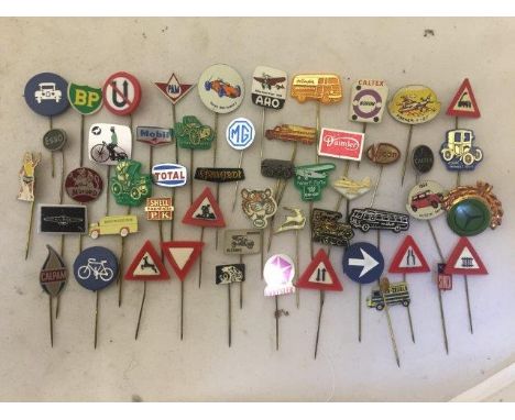 A quantity of pin badges, tie pins etc. all with a motoring theme including miniature road signs, oil brands etc. 