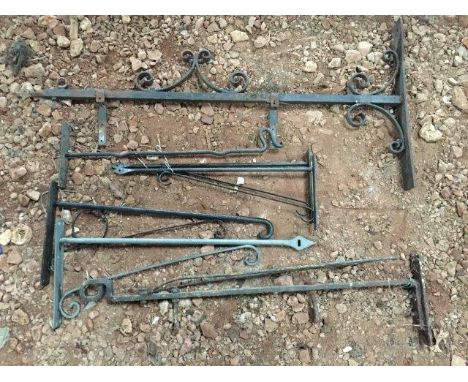 A selection of wrought iron enamel sign wall mounted brackets.