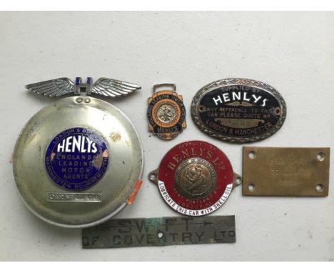 A Henlys Limited red enamel car badge with central St. Christopher, a Henlys supply plate and various other dash badges, lice