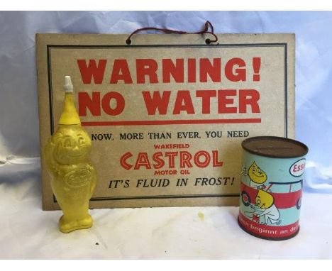 A Wakefield Castrol Motor Oil 'Warning No Water' cardboard showcard, an Esso 'Handy Oil' rubber oil dispenser and a German Es