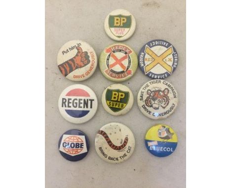Ten assorted motoring related badges to include BP, Redex and Regent. 