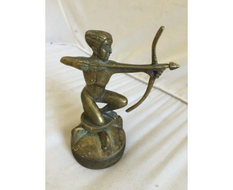 An unusual accessory mascot in the form of a figure with a bow and arrow, indistinctly signed Andal, mounted on a radiator ca