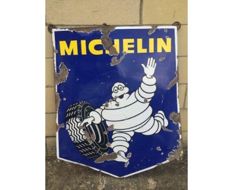 A Michelin enamel sign with an image of Mr. Bibendum rolling a tyre, 27 x 31 1/2".
