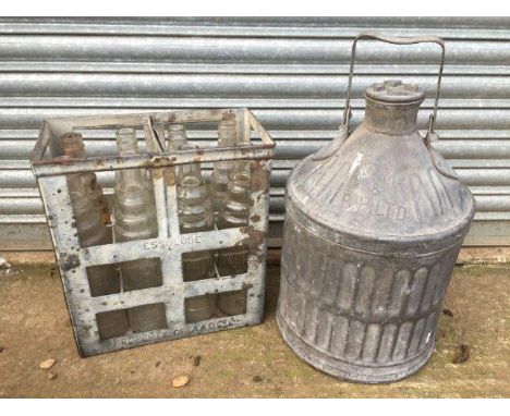 A Shellmex and BP Limited galvanised cylindrical pyramid can and an Essolube eight bottle oil bottle crate.