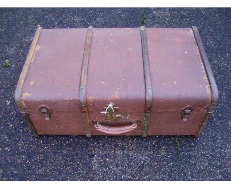 A large travelling trunk, lined, complete with keys and lift-out tray insert, with good leather handle and metal reinforcemen