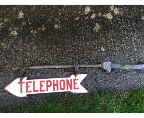 A double sided hanging directional enamel sign - Telephone, with original bracketry, 23 x 5 1/2" (sign only).