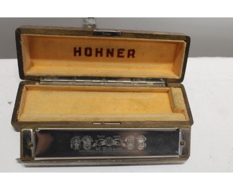 A cased M Hohner Chromonika iii mouth organ 