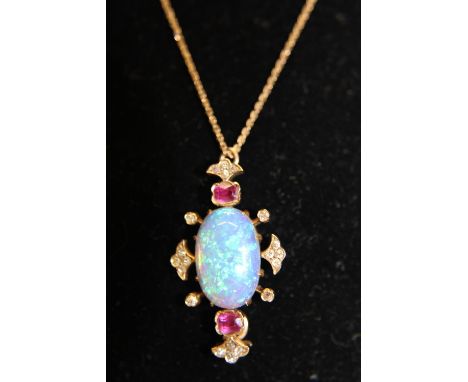 A beautiful 14ct gold pendant and chain with a large central opal flanked by two rubies &amp; diamonds 