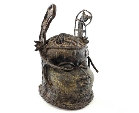 A Benin heavy bronze head of an oba, 20th century, with ornate pierced raised headdress and lattice coiffure, height 28cm.