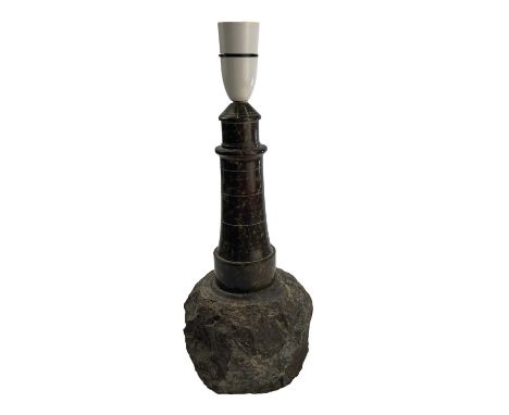 A Cornish serpentine turned and polished lighthouse table lamp on a rock base, height 30cm.