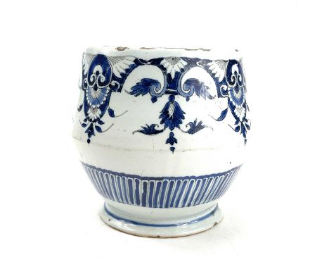 An unusual shaped delft bowl decorated in blue and manganese with floral swags and pendants above a painted reeded panel circ