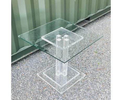 A mid-century lucite centre table with four vertical supports and a stepped base with a bevel edge glass top, height 53.5cm, 