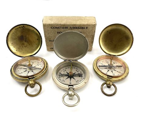 A WWII Longines-Wittnauer compass with original packaging diameter 4.5cm together with two brass U.S.C.E compasses. (3)