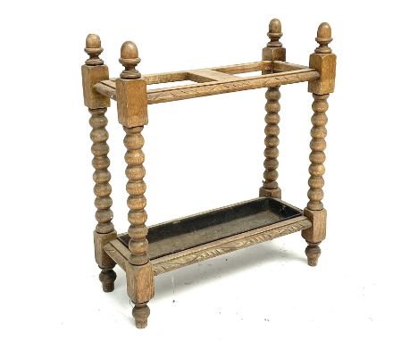 A late Victorian oak stick stand, with bobbin turned supports, metal liner, height 70cm, width 61cm, depth 25cm.