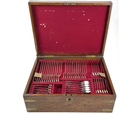 A Victorian brass bound oak cased canteen of plated cutlery, Old English pattern, with two removable trays, the lid with inse