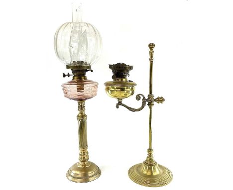 A late Victorian adjustable brass oil lamp, with a swan neck arm on a circular base, height 60cm, together with a brass corin