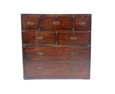 A Victorian mahogany campaign secretaire chest, in two parts, with a central drop-front drawer with a fitted interior and fla