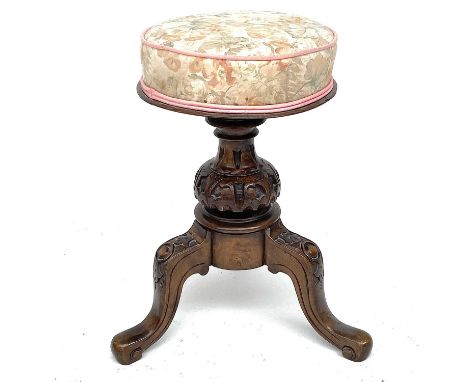A Victorian walnut circular piano stool, with adjustable top on a carved tripod base, height 53cm.