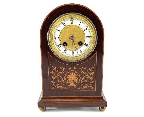 An Edwardian mahogany and inlaid dome top mantel clock, the gilt brass face with cream chapter ring, the French movement stri