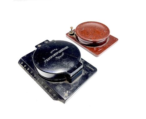 A USSR made bakelite compass with Cyrillic inscription on the silvered dial, together with another USSR made black plastic co
