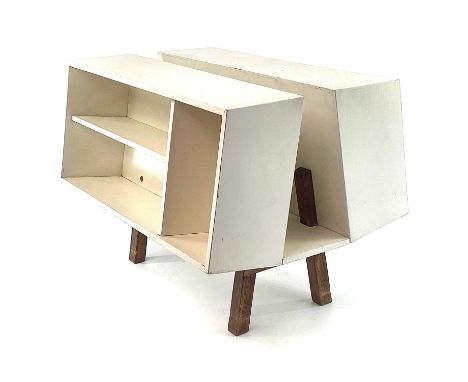 An Isokon Penguin Donkey Mark 2 book tidy, designed by Ernest Race, with white painted finish and raised on mahogany legs, wi