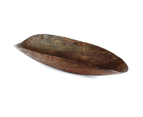 Aboriginal art Northern Australia, a coolamon with adze carved with remnants of original pigments, length 67cm width 24cm.Pro