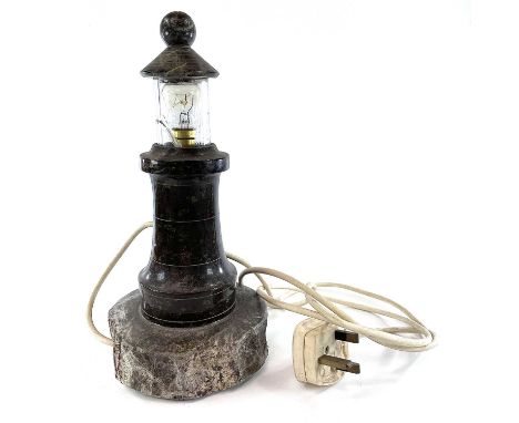 A turned and polished Cornish serpentine turned lighthouse table lamp with a removable glass top on a naturalistic base, heig