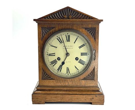 An oak mantel clock, German, circa 1900, the white painted dial inscribed John Elkan, Liverpool St, City, the movement striki