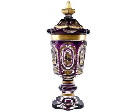 A 19th century Bohemian amethyst flash and gilt goblet and cover, with steeple knop and engraved floral decoration, height 30
