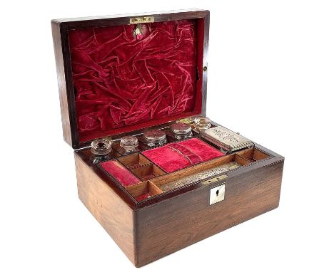 A Victorian rosewood veneered mother of pearl inlaid toilet box velvet lined with silver plated bottles and box with sectione