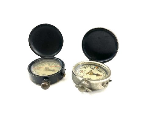 A WWI brass and lacquer hunters compass stamped England, diameter 4cm together with a similar nickel cased compass. (2)