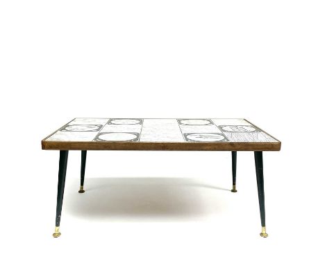 A circa 1950 Poole pottery tile coffee table inset with fifteen tiles with tapering legs and brass feet, height 35cm width 79