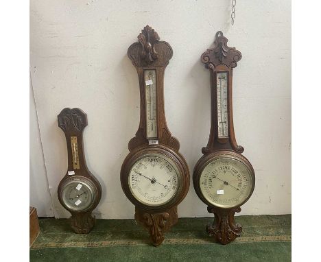 An oak aneroid barometer, the white dial signed Rankin &amp; Forbes, Kilmarnock, height 89cm, together with two other oak bar