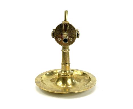 A 20th century brass cigar cutter in the form of a ship's engine order telegraph E.O.R or Chadburn on a circular brass ashtra