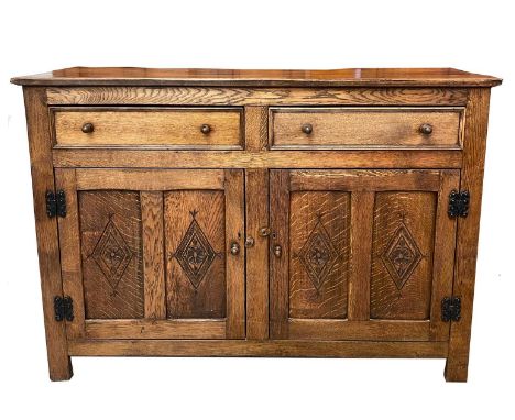 An oak sideboard, mid 20th century in the Georgian style, fitted two short drawers above two carved panel doors, height 89cm,