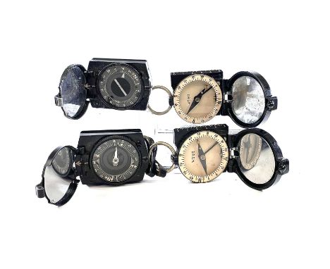 A WWII German marching compass moulded c x n marks with leather case together with another similar compass and two Busch Rath
