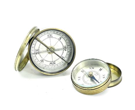 An early 20th brass compass with a printed card dial and brass cover, diameter 5cm together with a smaller French made brass 