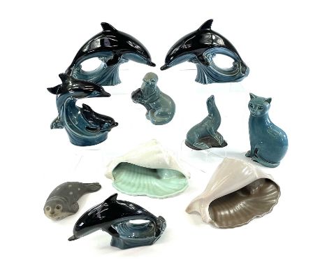 A Poole pottery dolphin figure together with seven other Poole pottery animal figures and two Poole pottery shells, largest h