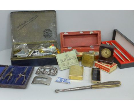 A novelty Bakelite clock read out tape measure, lighters, a travel inkwell, two Georgian buckles, etc. 